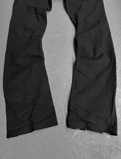 Black pants on a gray textured surface