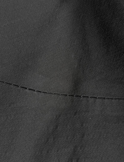 Close-up of black leather texture with stitching detail
