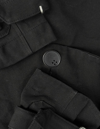 Close-up of a black button on a black fabric background