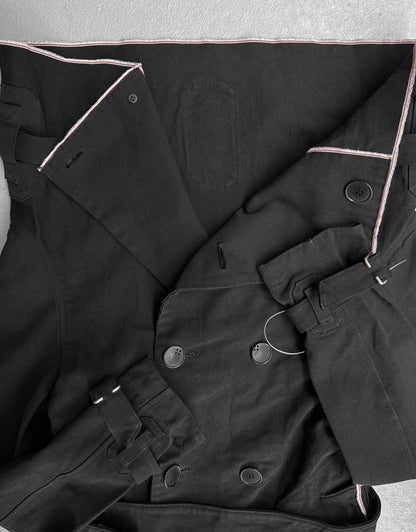 Close-up of a black coat with buttons on a light gray background