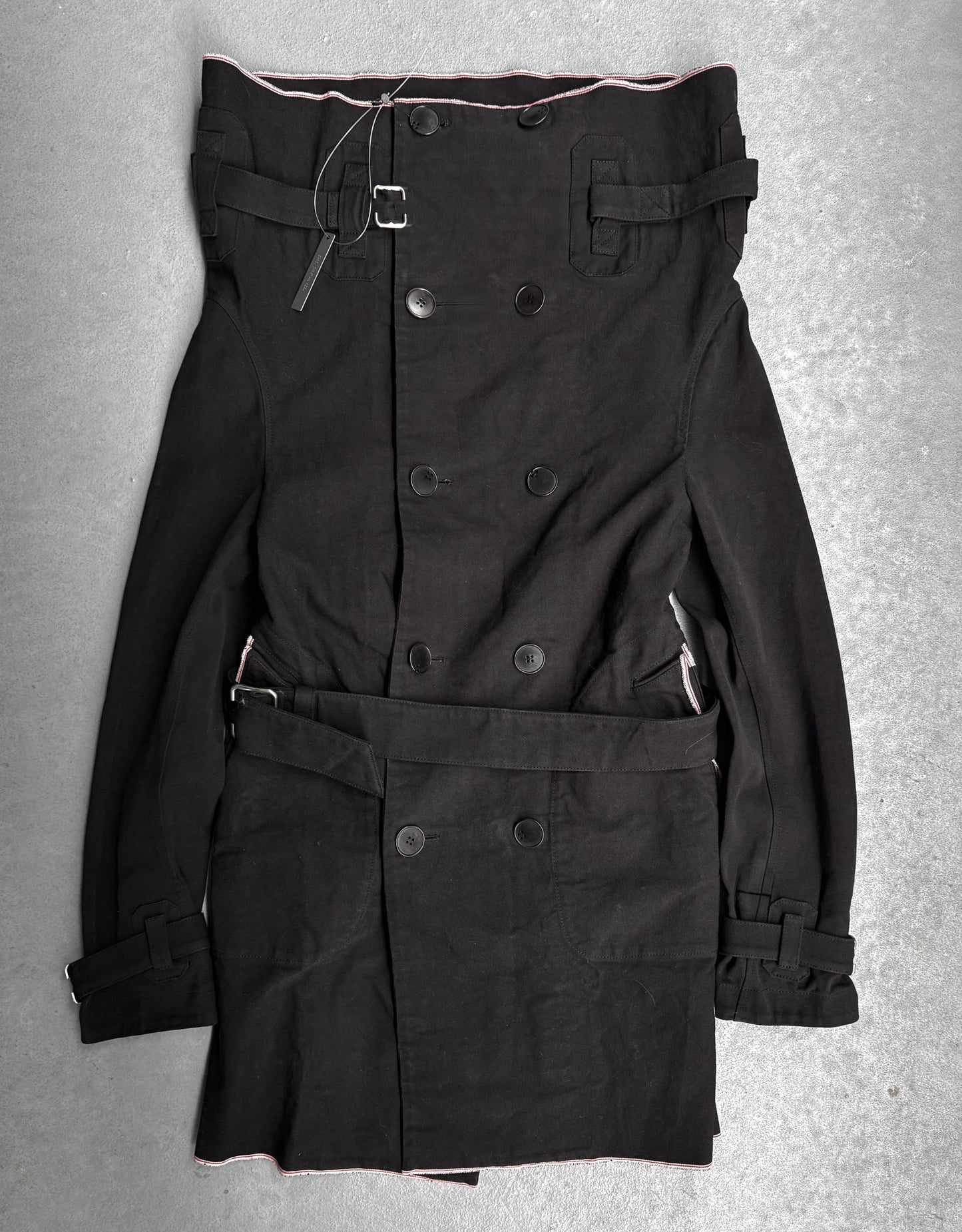 Black trench coat with belt on a gray background