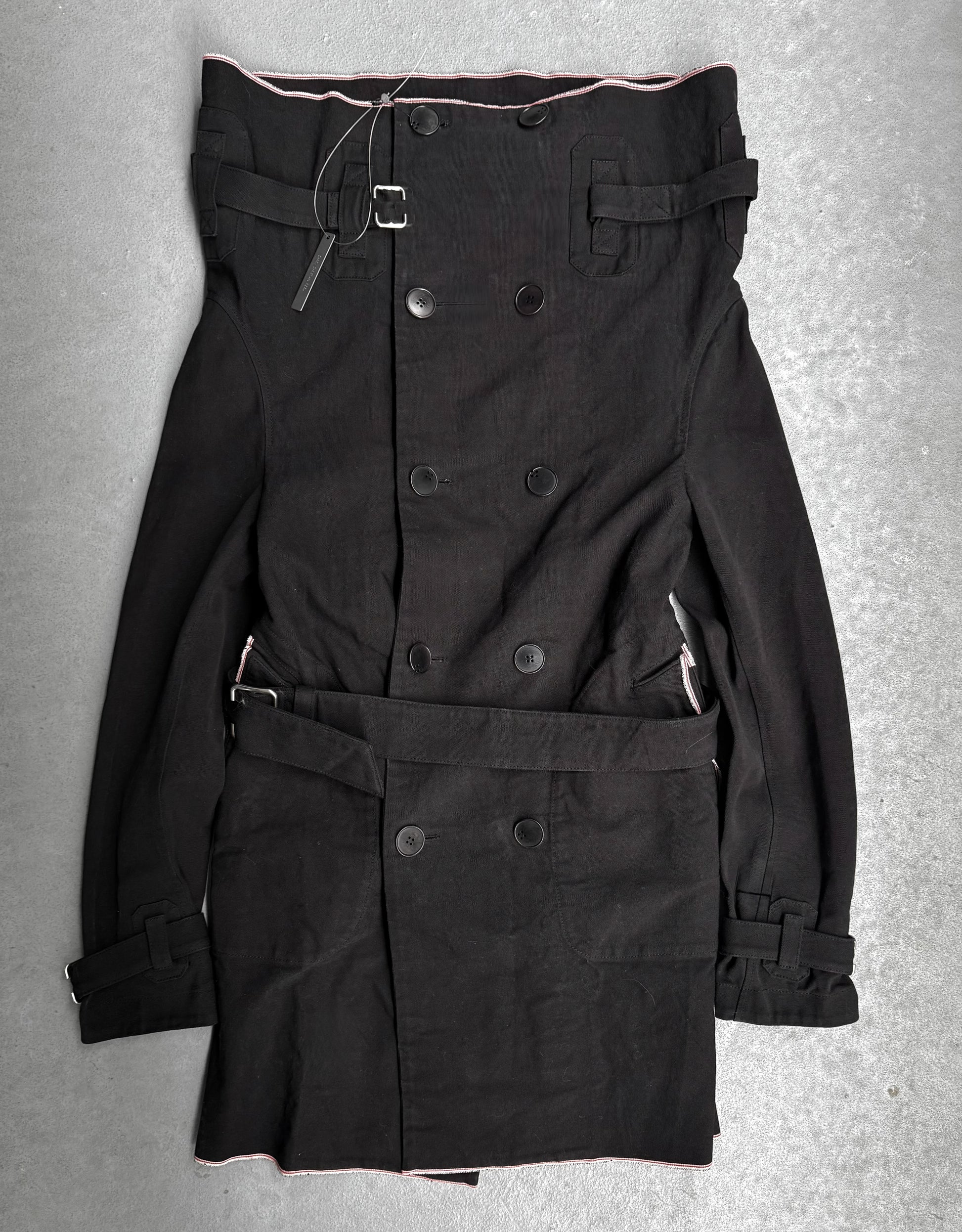 Black trench coat with belt on a gray background