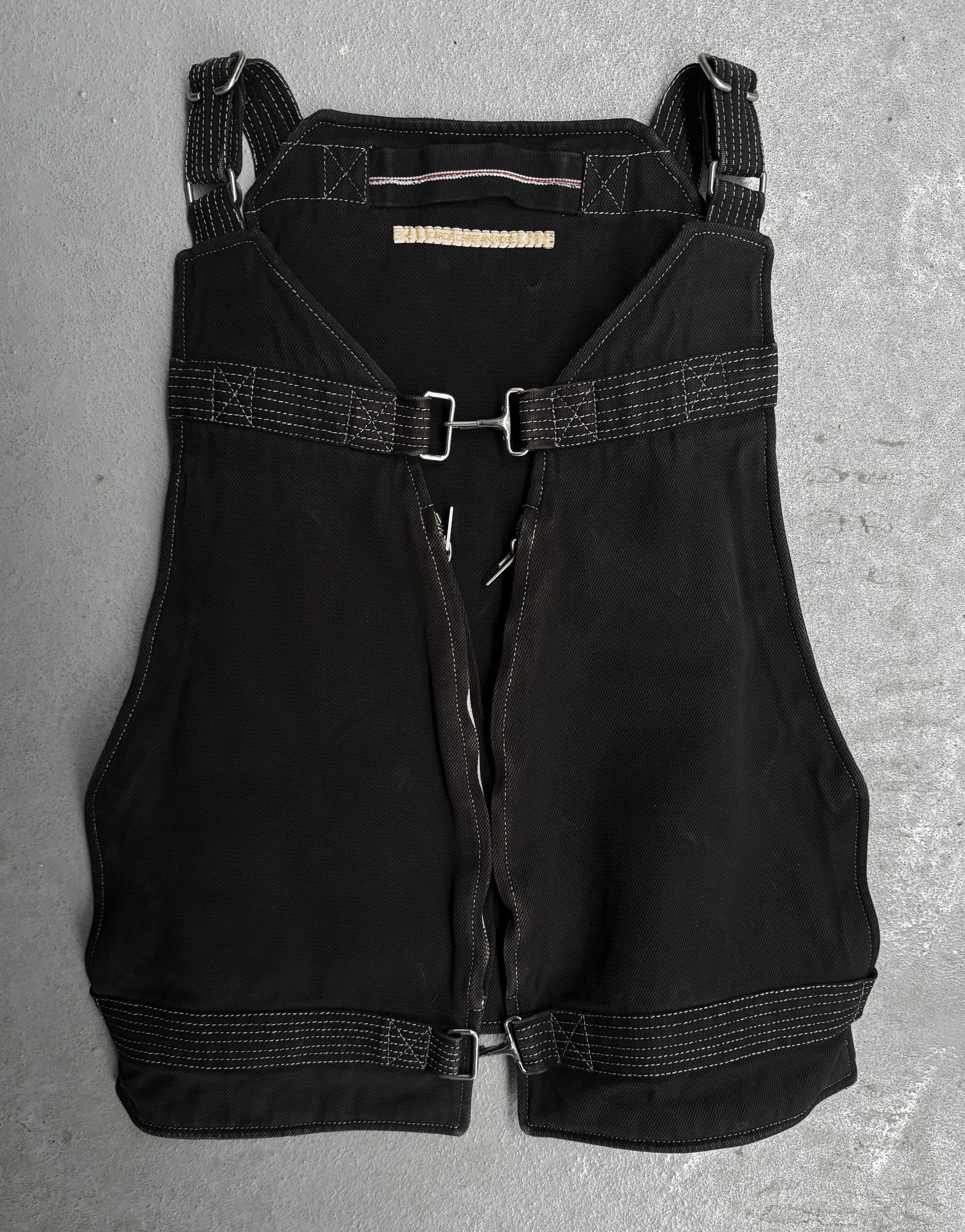 Black overalls with straps on a gray surface
