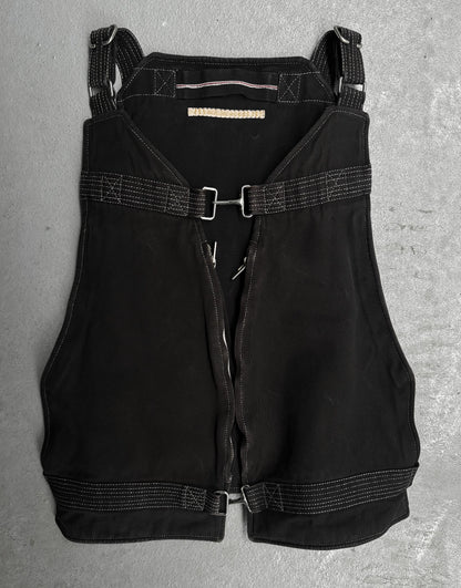 Black overalls with straps on a gray surface