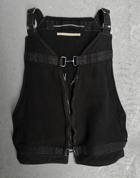 Black overalls with straps on a gray surface