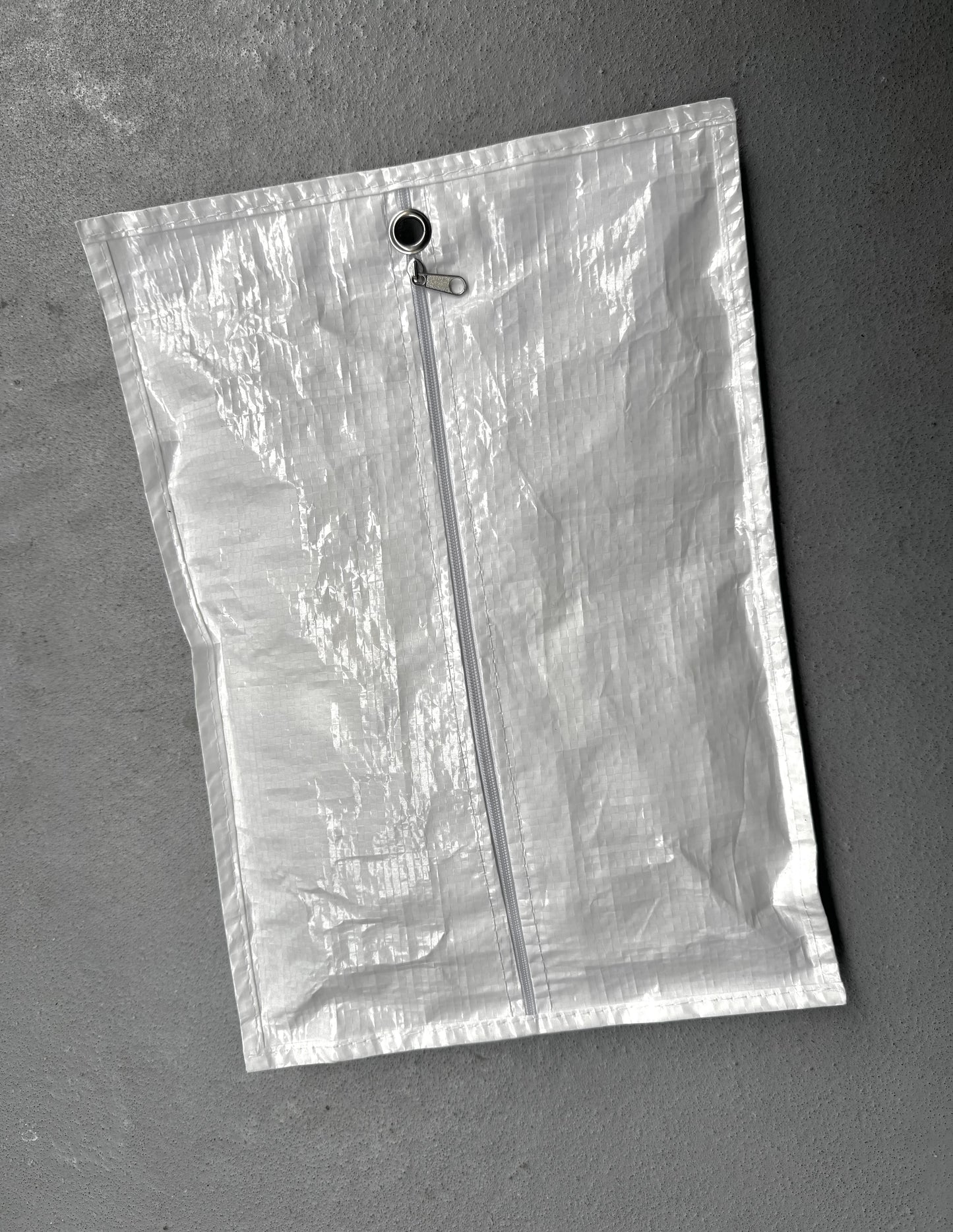 Clear plastic bag with a zipper on a gray background