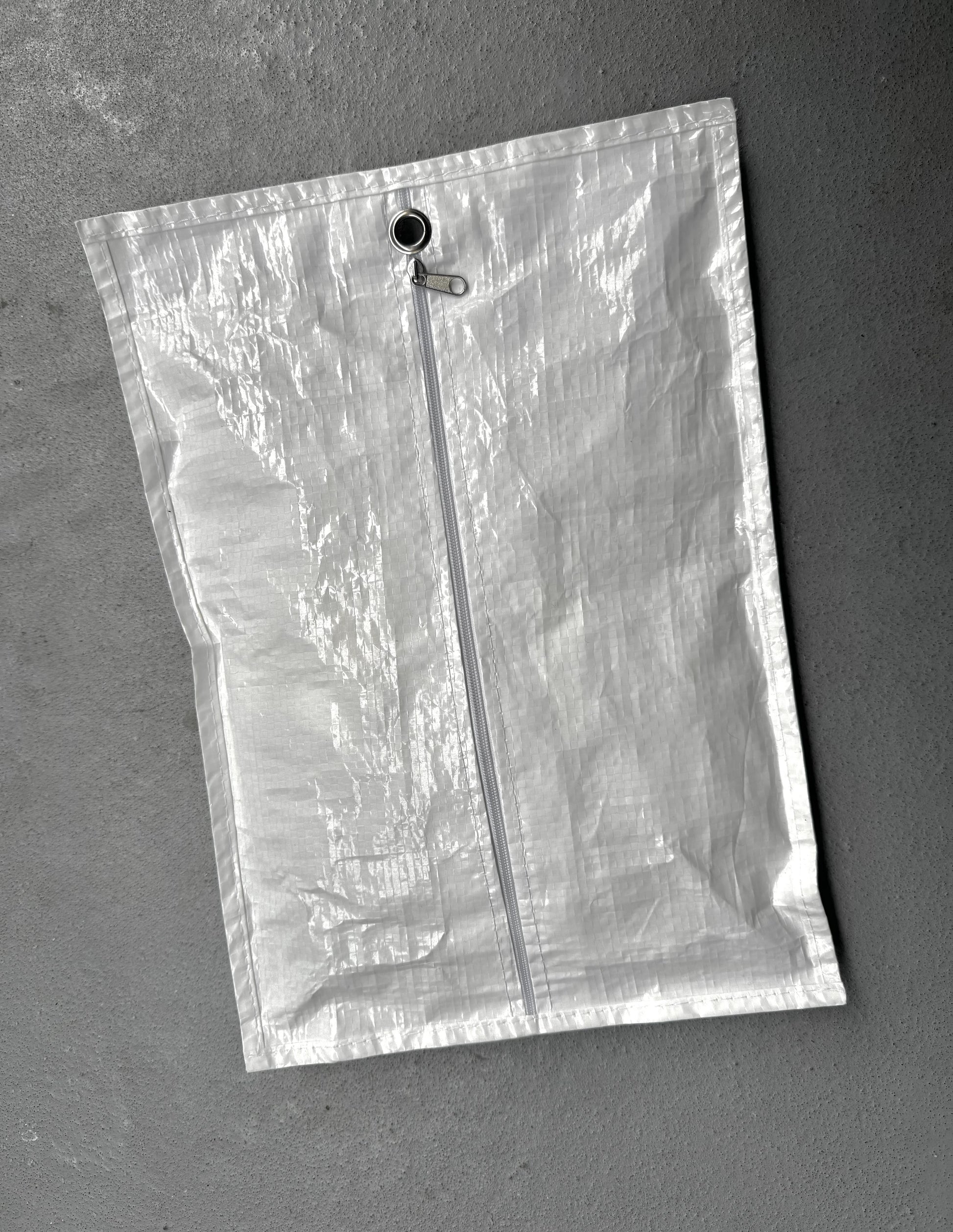 Clear plastic bag with a zipper on a gray background