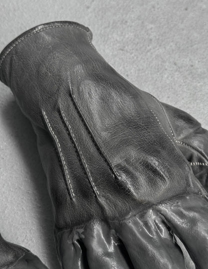 Close-up of a black leather glove on a gray background