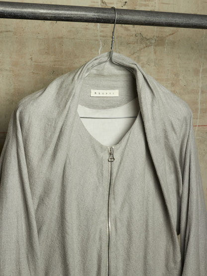 A light gray zip-up jacket with an oversized draped collar, hanging on a metal hanger from a dark metal rod against a textured beige wall. The brand name 'BERRY' is visible on the inner neck label.