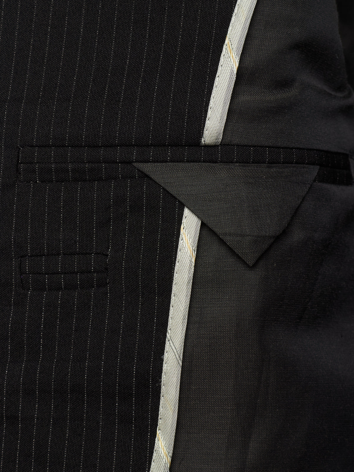 Close-up of a black pinstripe suit jacket showing the fabric texture, a notch lapel, and a light-colored decorative center stripe.