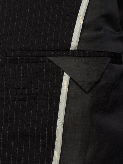 Close-up of a black pinstripe suit jacket showing the fabric texture, a notch lapel, and a light-colored decorative center stripe.