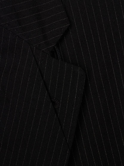 Close-up of a black pinstriped fabric, showing fine vertical white stripes on a textured material.