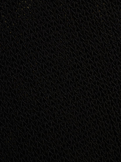 A close-up texture shot of a black woven fabric, showing a fine diagonal pattern.