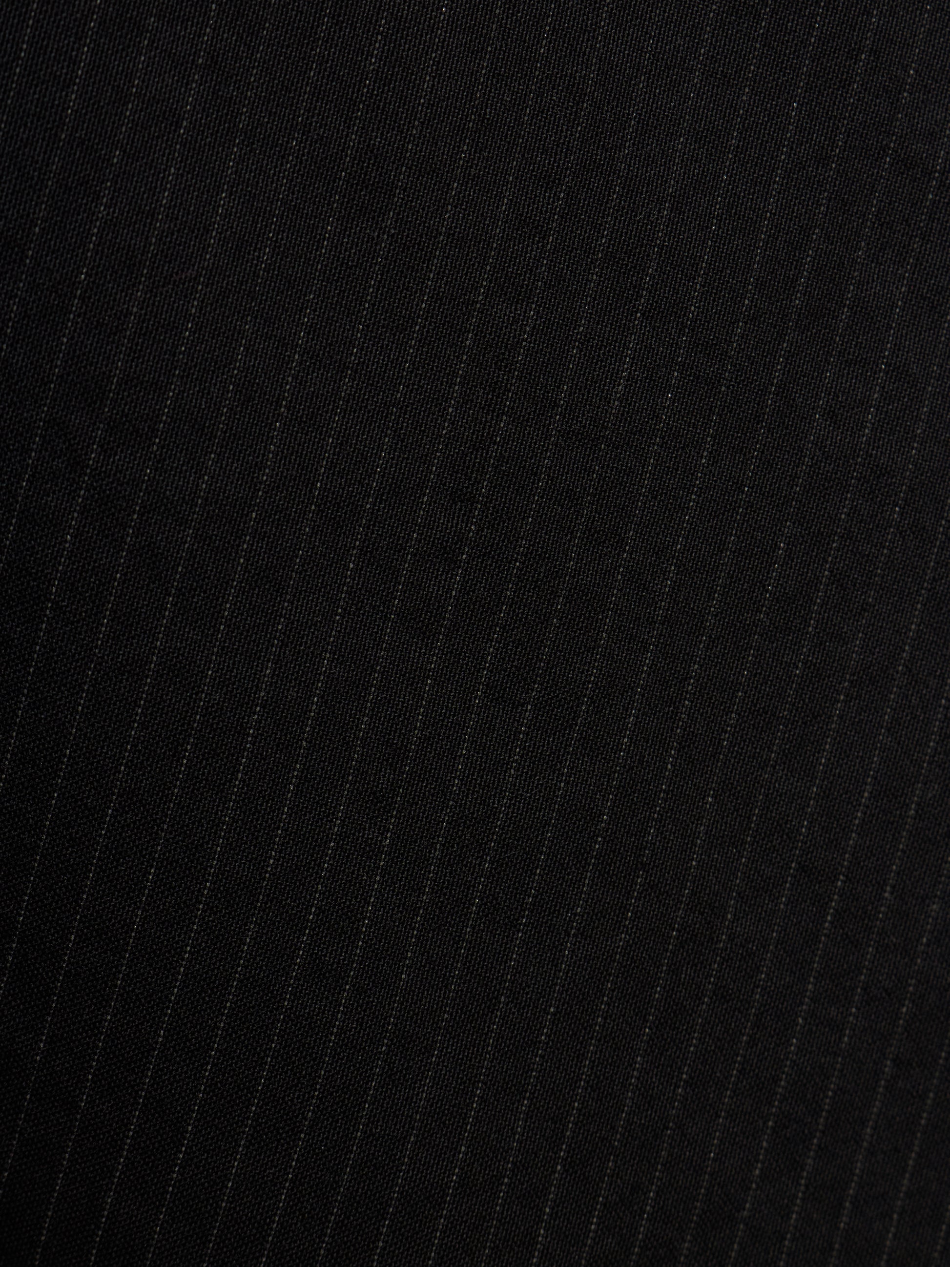 Close-up of a black fabric with thin vertical white pinstripes.