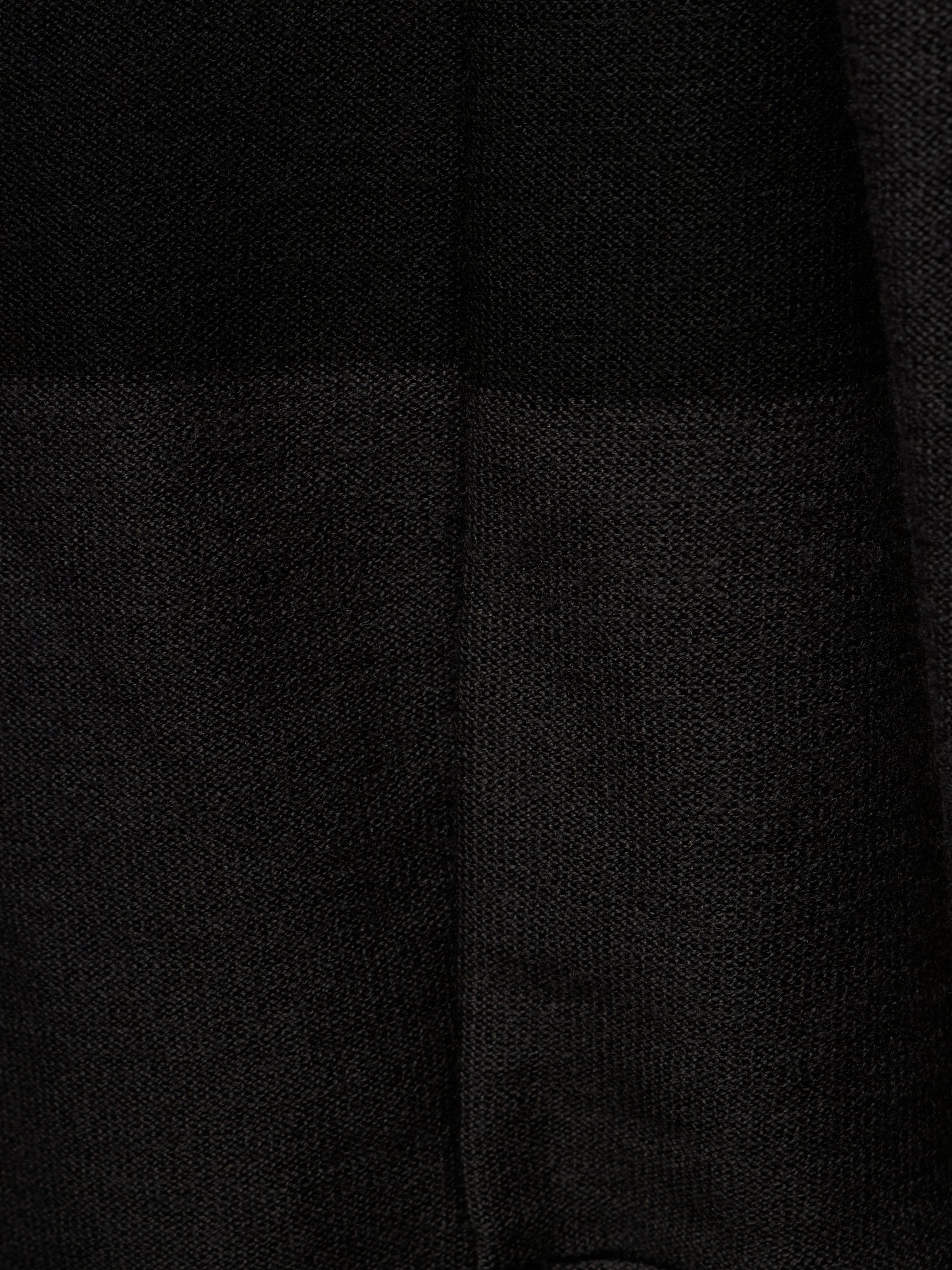 Close-up of a black textured fabric with a subtle woven pattern and a vertical seam.