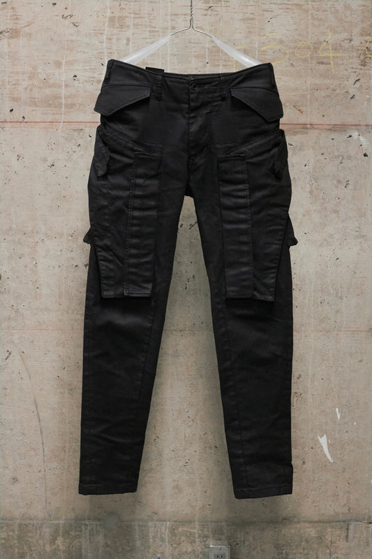 Black cargo pants on a textured beige background