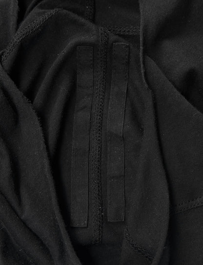 A close-up of black fabric with two parallel black velcro strips, inspired by Rick Owens DRKSHDW AW24 “PORTERVILLE” Geometric Level Long-sleeves, nodding to the brand’s iconic avant-garde aesthetic.