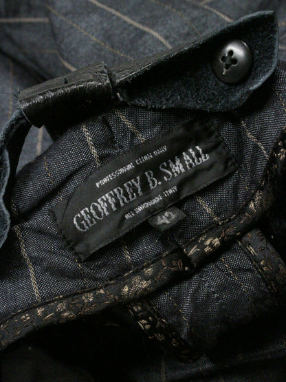 Close-up of a label on a dark fabric garment with a button.