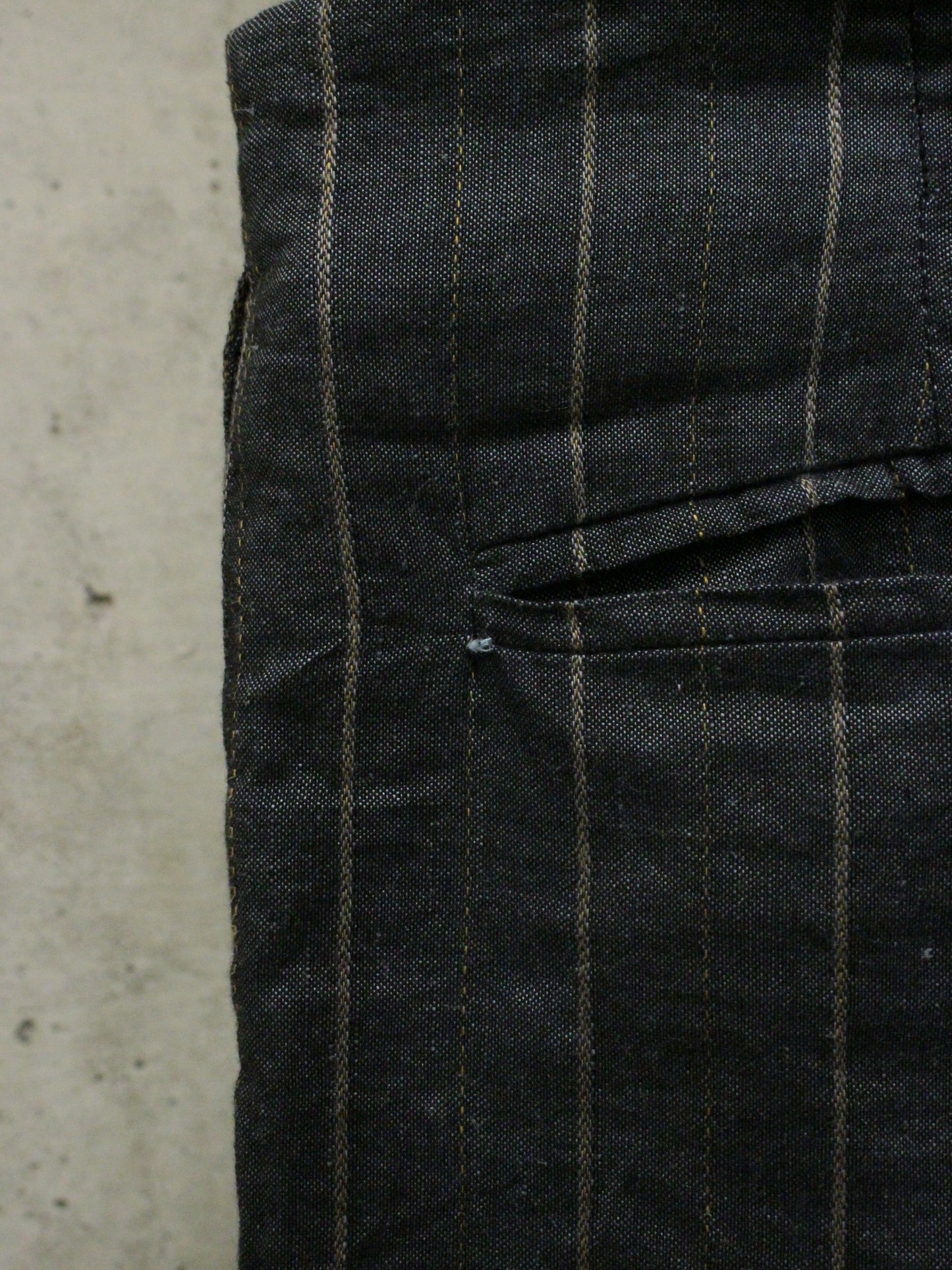 Black checkered pants on a concrete surface