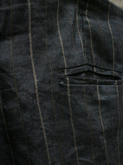 Close-up of a dark pinstripe fabric with a pocket detail