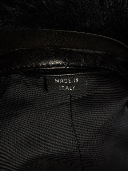 Close-up of the interior collar of a black garment with a black faux-fur trim and a sewn-in label reading 'MADE IN ITALY'.