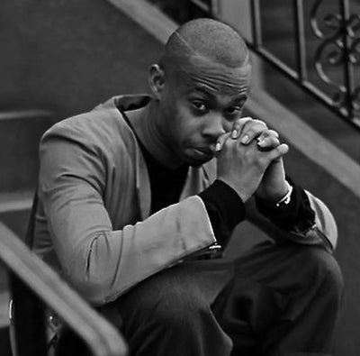 Shane Oliver sitting on stairs in black and white — founder of Hood By Air, known for experimental streetwear