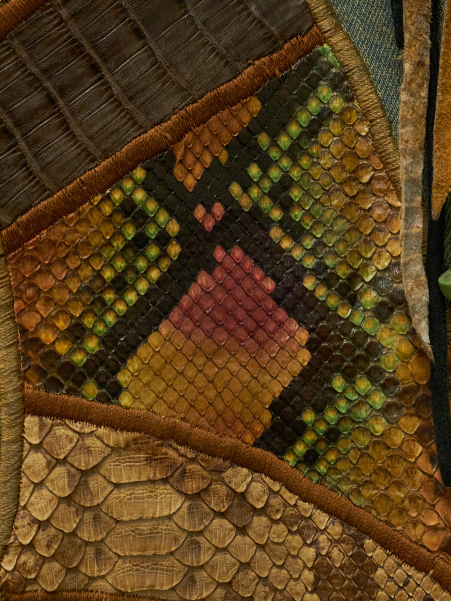 Close-up of a textured fabric patch with geometric patterns in earthy tones.