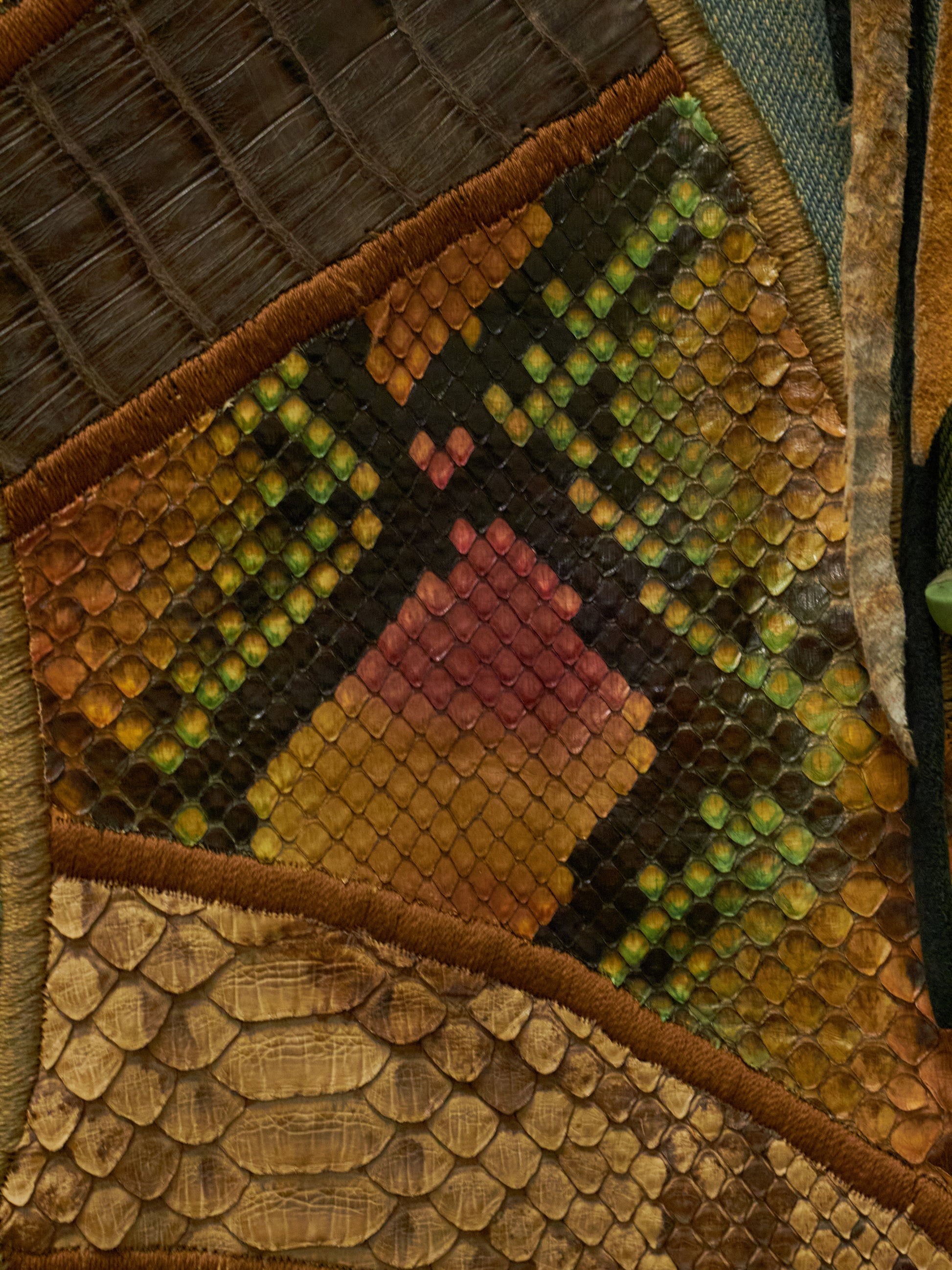 Close-up of a textured fabric patch with geometric patterns in earthy tones.
