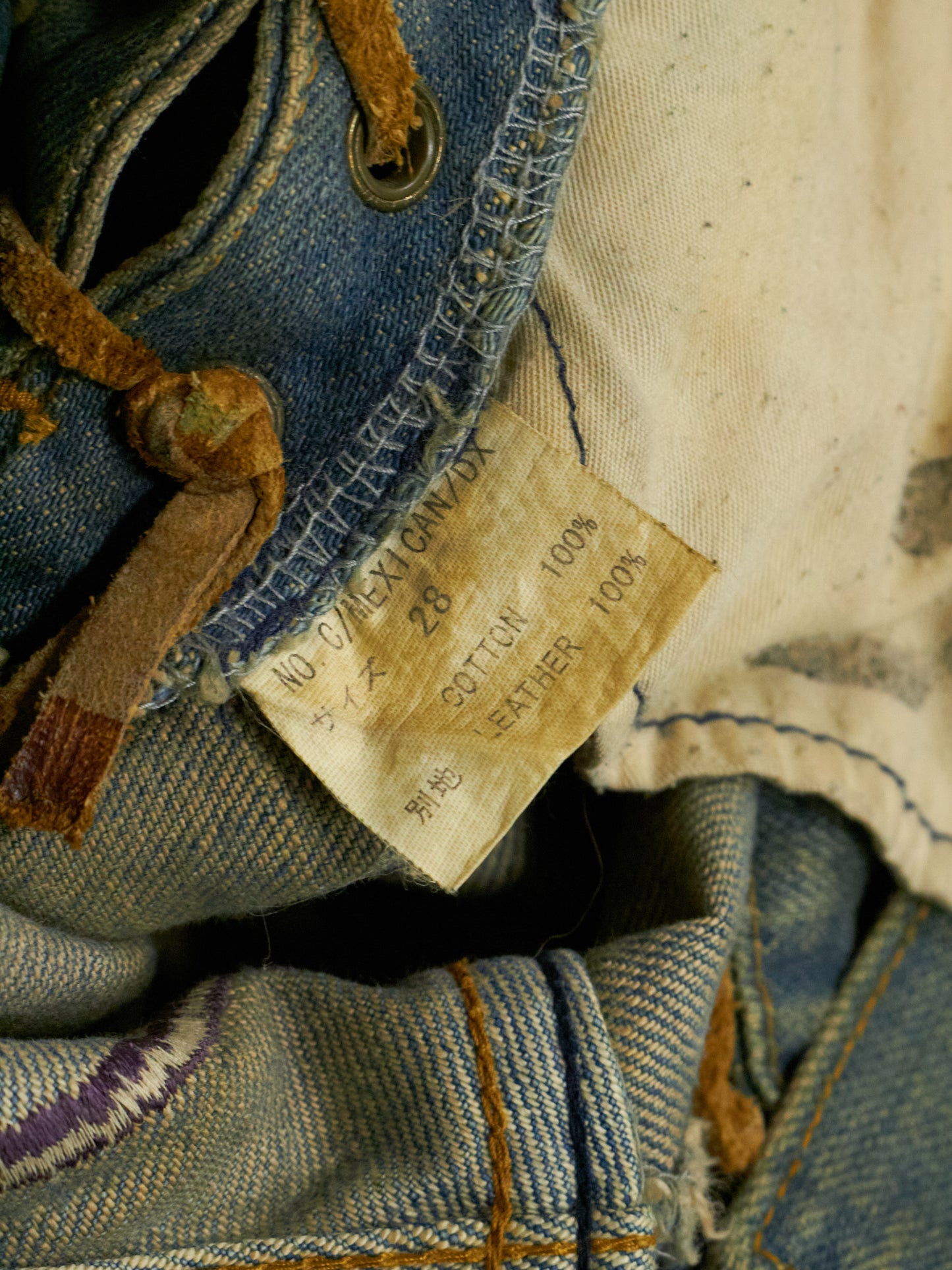 Close-up of a denim fabric with a label and stitching details