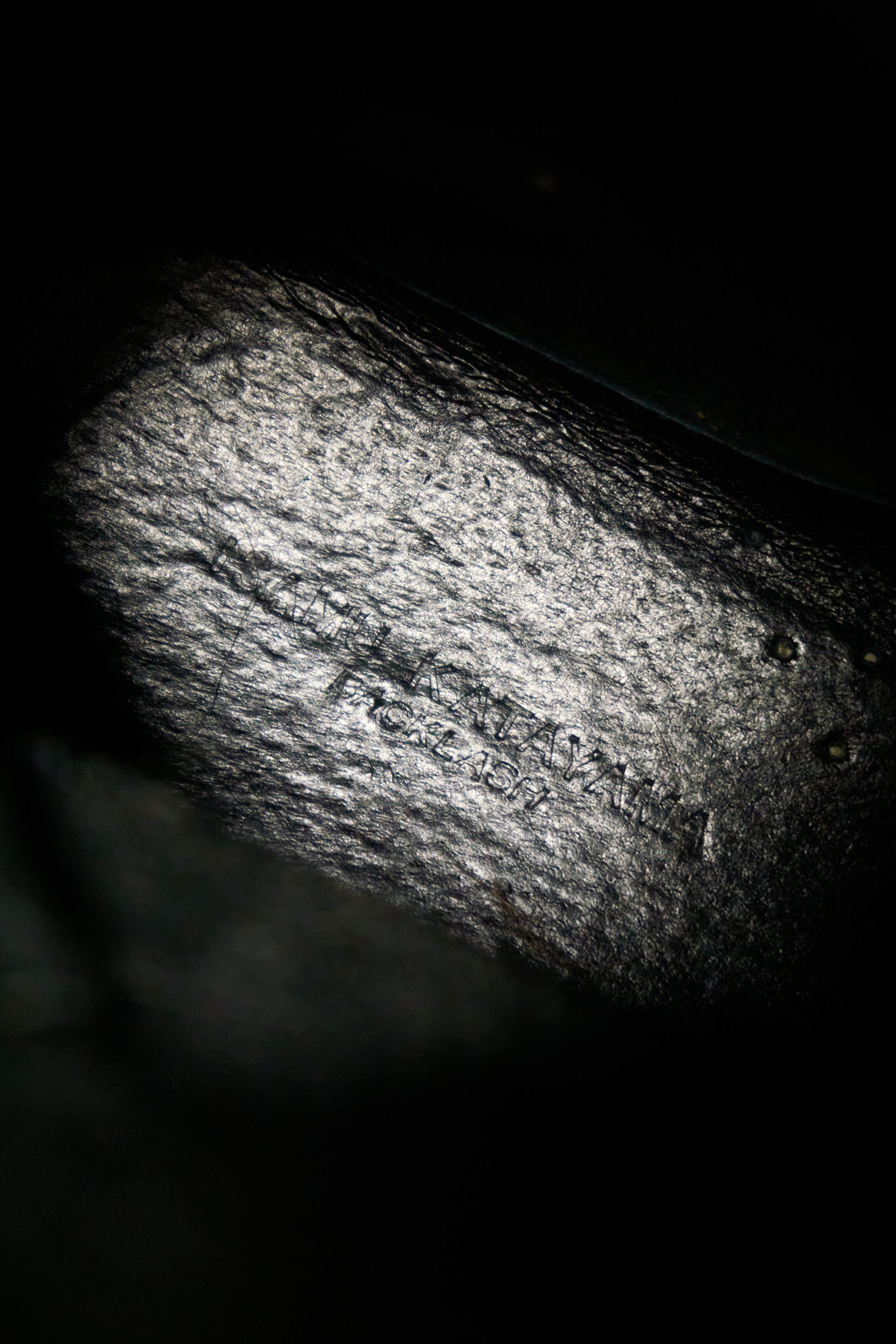 Close-up of a textured surface with 'Made in Italy' text on a dark background