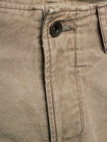 Close-up detail of a pair of brown twill pants showing the button closure and pocket stitching.