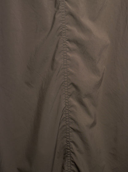 Close-up of a dark taupe-brown fabric with a central vertical seam and stitched edge detail.