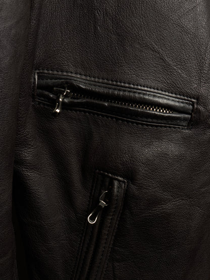 Close-up of a black leather jacket showing a zippered pocket and a vertical zip detail with silver-toned hardware.