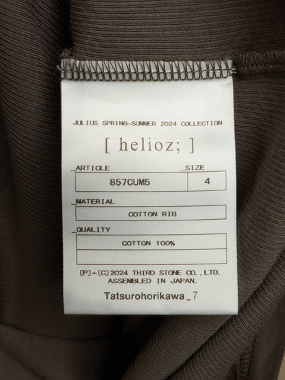 A close-up of a garment's interior label reading 'helioz;' and 'Julius Spring-Summer 2024 Collection,' with details including article number 857CUM5, size 4, cotton rib material, and cotton 100% quality.