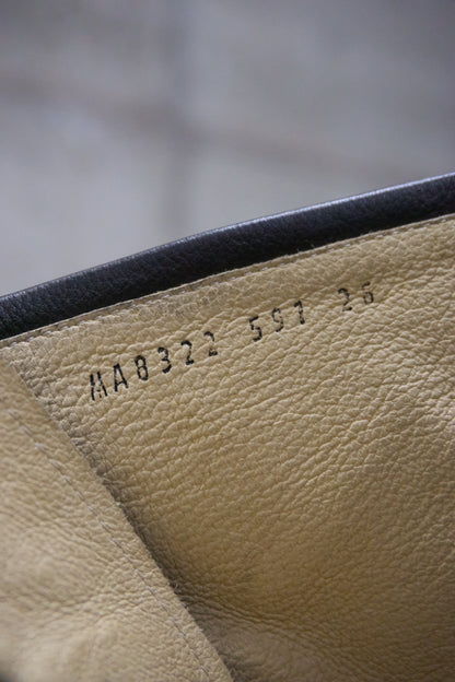 Close-up of beige leather with embossed text on a blurred background