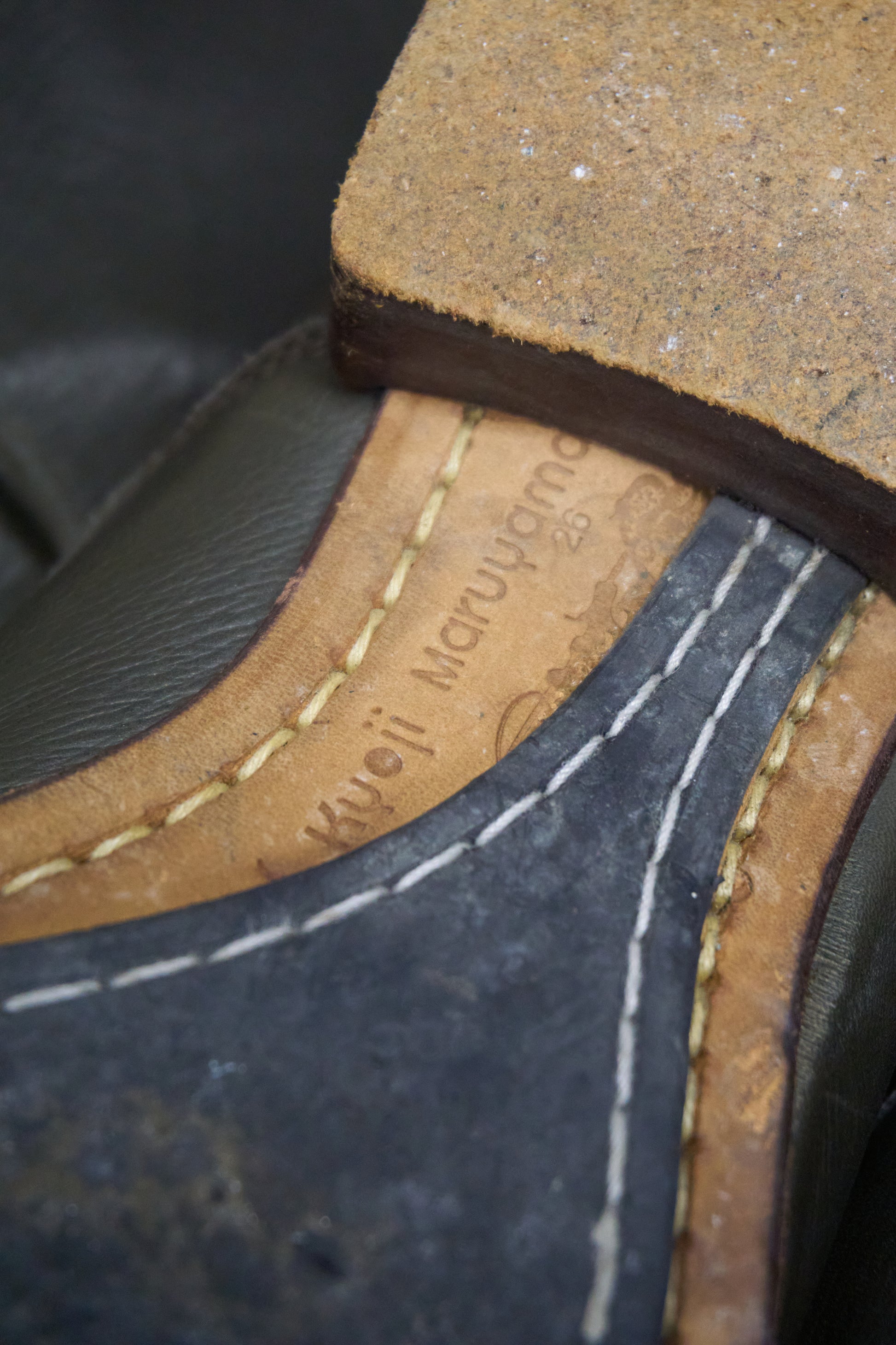 Close-up of a shoe with 'Woolrich' branding on the sole.