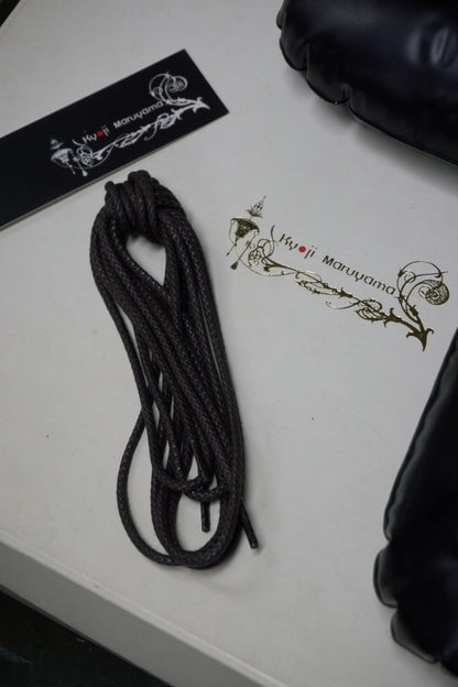 Black rope on a white surface with branding visible