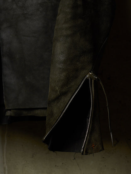 A close-up of a dark brown leather jacket with a silver zipper detail and a drawstring, set against a dark background.