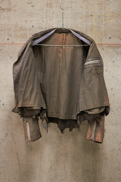 Rustic brown jacket hanging on a concrete wall