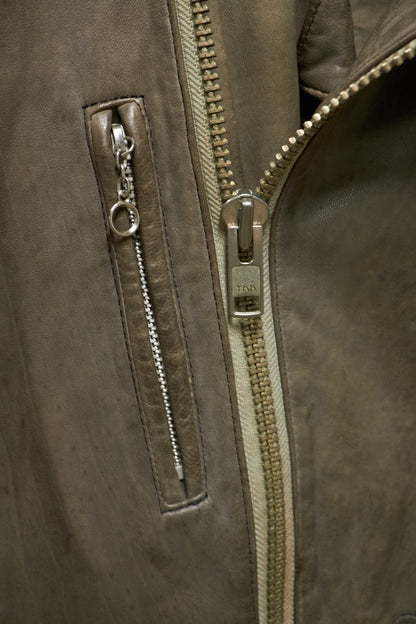 Close-up of a brown leather jacket with a zipper