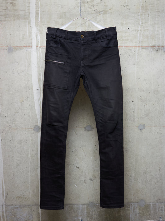 Black pants hanging on a textured wall