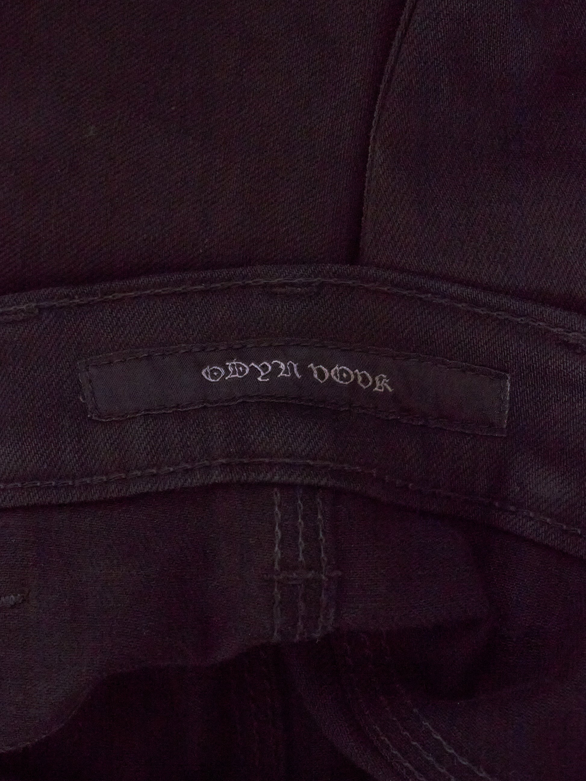 Close-up of a dark fabric with a brand label on a dark background