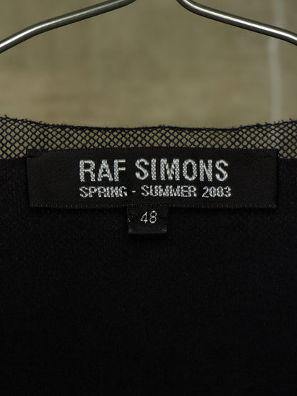 Close-up of a black Raf Simons Spring-Summer 2003 knit garment on a hanger, showing the brand label and size 48.