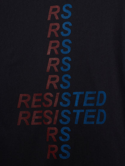 Close-up of a black textured fabric with a vertical graphic spelling 'RESISTED' in alternating red and blue letters.
