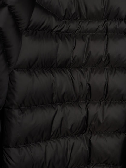 Close-up of a black puffer jacket showing horizontal quilting and a smooth, slightly shiny fabric texture.