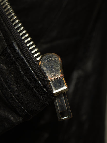 Close-up of a black leather zipper with a silver-toned metal pull tab engraved with the brand name 'GOGOLD'.