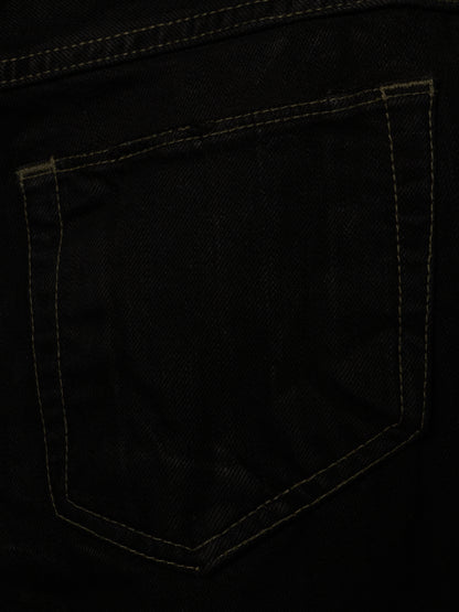 Close-up of a black denim pocket with contrasting tan stitching.