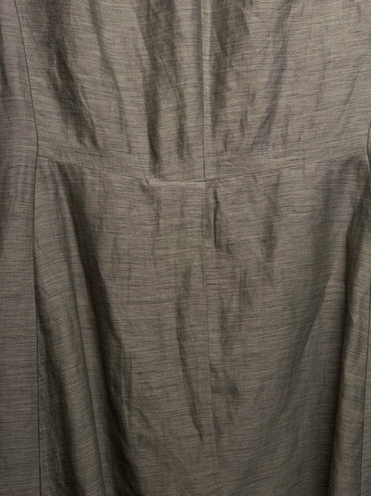 Close-up of a textured gray fabric with a fine slub or linen-like weave, showing folds and a vertical seam.