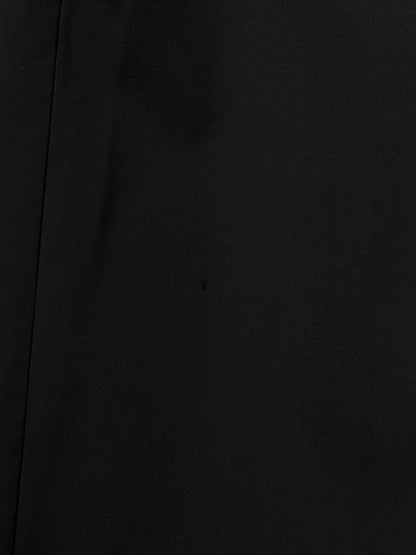 A close-up of a solid black textured material, likely a dark woven fabric or leather, with a subtle vertical seam on the left side.