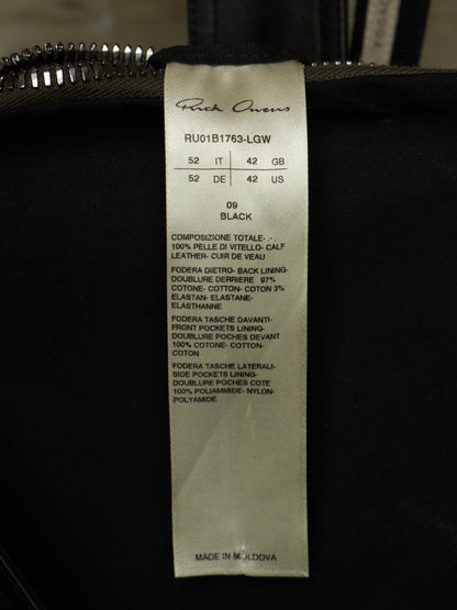 A close-up of a black garment's interior tag showing the brand 'Rick Owens' and size information for a black shoe.
